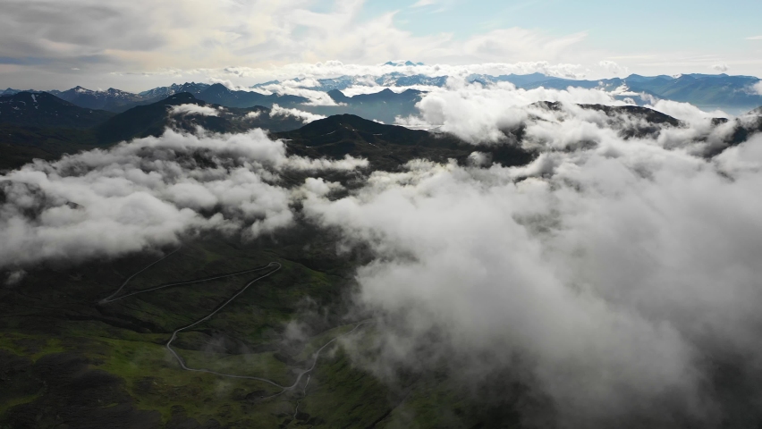 Aerial view of mountains peaks with low clouds, Unalaska island, Alaska, United States.