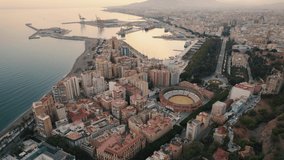 drone shot aerial of the city of Malaga, Spain at dusk. 4K videos. tilt down.