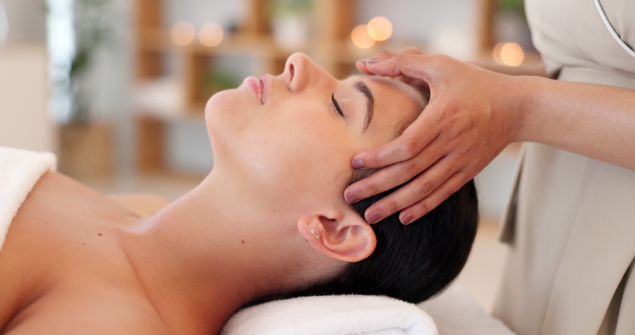 Wellness, spa and woman getting facial massage in beauty salon to relax. Calm, peace and luxury treatment for skin, massage therapy for stress relief, skincare and beautician massaging face of client | Shutterstock HD Video #1096066291