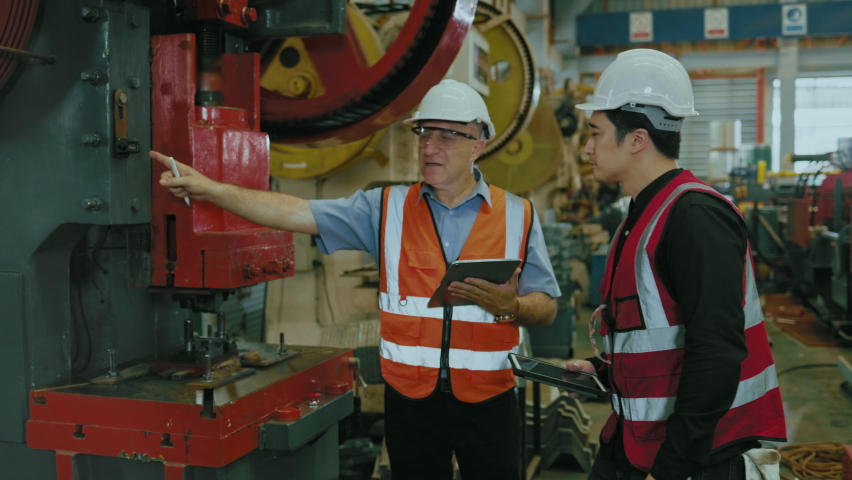 Two caucasian engineers are meeting to find a solution to the problem, improve of the machines, production line in the factory. Male Specialist in Vests hard work in Production steel industrial Royalty-Free Stock Footage #1096069923