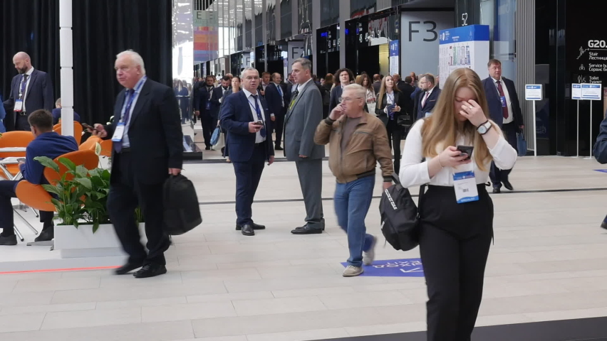 S-Petersburg, Russia, Sept. 2022 - A crowd of people at the exhibition. People walk on exhibition hall. Timelapse.