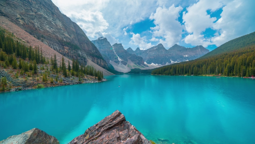 4K time-lapse UHD video of  beautiful view of an iconic famous place, Moraine Lake, a glacier lake located in Banff National Park,Alberta, Canada, in a colorful sunset cloudy summer autumn day.  Royalty-Free Stock Footage #1096080221