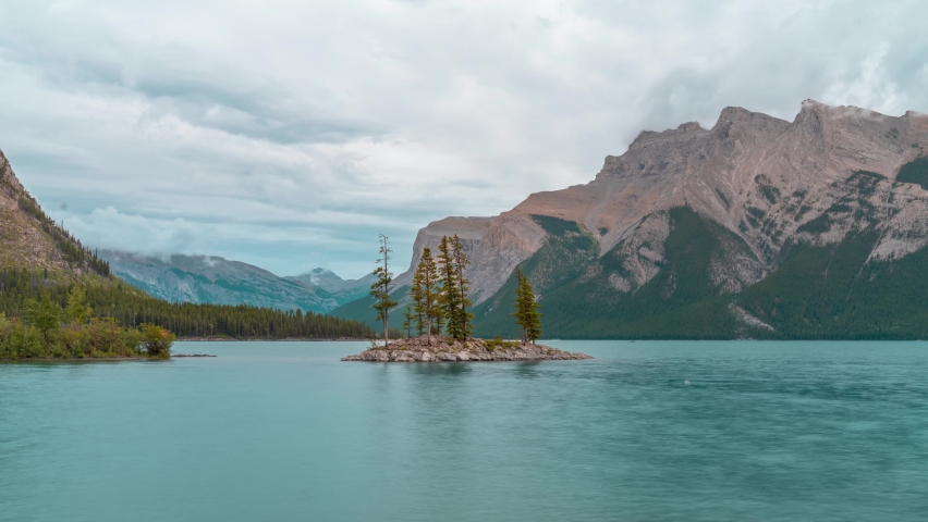 4K time-lapse UHD video of Small island with trees on  Minnewanka lake,a Glacial Lake and the 2nd longest lake in the mountain parks of the Canadian Rockies in Banff Alberta Canada