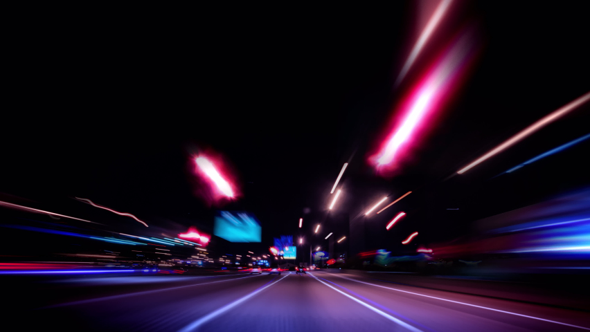 Technology Concept: High Speed Driving on Night City Highway Bright Light trails , Car driving Through Model City with Neon Light at Night, Modern City traffic at night.  Royalty-Free Stock Footage #1096082549