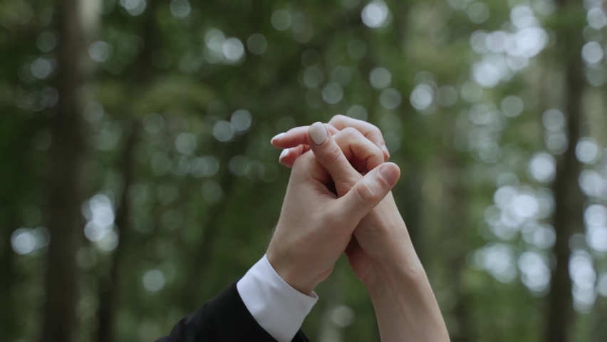 Caucasian male and female palms of hands touch, gently stroke each other on green background. Man arm with white cuff slowly moves down woman wrist. Concept of parting, breaking up relationships. Royalty-Free Stock Footage #1096083761