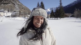Happy woman having fun in a winter mountains valley. Snowy landscape in the forest. High quality 4k footage