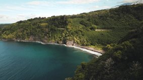 Drone video of beach alongside the road to Hana in Maui Hawaii on a sunny day