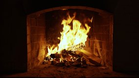 Warm Cozy Fireplace with Real Wood Burning in it. Cozy Winter Concept. Slow Motion. A Looping Clip of a Fireplace with Medium Size Flames. UHD TV screen saver. Video for meditation - Powered by Shutterstock - Get 15% off with code: PIKWIZARD15