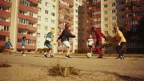 Young Boy Running from School, Throwing His Backpack on the Ground and Starting to Play Soccer with His Neighborhood Friends Outside. Multicultural Kids Play Football Together in the Suburbs. - Powered by Shutterstock - Get 15% off with code: PIKWIZARD15