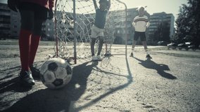 Young Black Boy Playing Soccer with Diverse Friends. Multiethnic Kids Enjoying a Game of Football in the Neighborhood. Player Celebrating the Goal. Fast Paced Tracking Shot. Cold Color Grading. - Powered by Shutterstock - Get 15% off with code: PIKWIZARD15