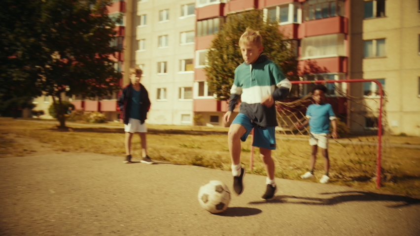 Neighborhood Kids Playing Soccer in Eastern European Backyard. Young Football Players Dribbling, Scoring a Goal. Boys and Girls Hug, Celebrate the Victory. Handheld Action Tracking Shot. Royalty-Free Stock Footage #1096102375