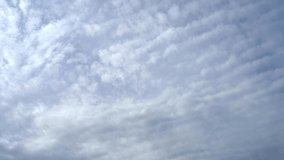 Altocumulus clouds moving across the sky in fast forward. Cloudy Sky. Cloudscape. Various layers of clouds move in different directions at altitude. 4k footage. - Powered by Shutterstock - Get 15% off with code: PIKWIZARD15