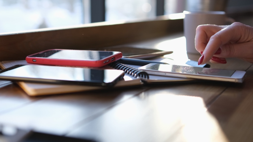 Handheld Camera: Point of View of Woman at a Chinese restaurant Sitting on a Chair Using Phone Surfing Internet Watching Content Videos Blogs Tapping on Center Screen