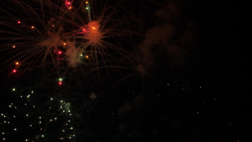 4k. Bright New Year's fireworks 2023. beautiful new year's eve. glowing loop christmas bokeh. holiday day christmas. beautiful bright color spot show. eve New Year's holiday. national festival sky Royalty-Free Stock Footage #1096117829
