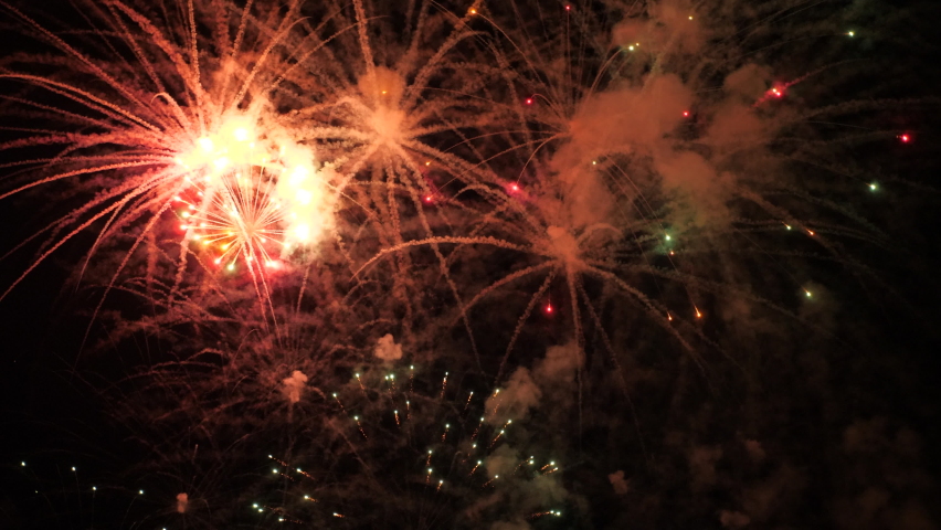 4k. Bright New Year's fireworks 2023. beautiful new year's eve. glowing loop christmas bokeh. holiday day christmas. beautiful bright color spot show. eve New Year's holiday. national festival sky Royalty-Free Stock Footage #1096117829