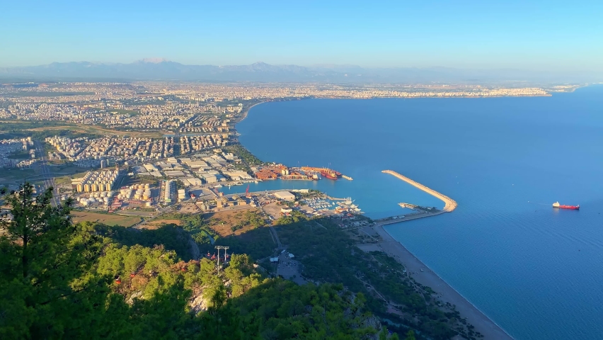 Aerial view of beautiful blue gulf and Konyaalti beach in popular resort city Antalya, Turkey. High quality photo