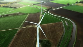 Aerial view of powerful Wind turbine farm for energy production. Wind power turbines generating clean renewable energy for sustainable development. 4k footage.