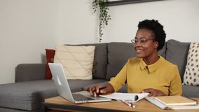 African American woman studying online course at home