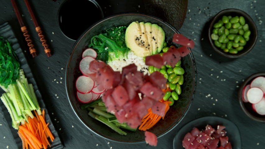 Super Slow Motion Shot of Fresh Tuna Cuts Falling into Poke Bowl at 1000fps. Royalty-Free Stock Footage #1096134381