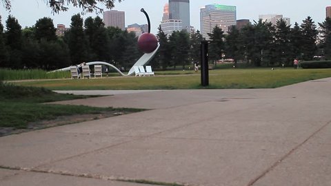MINNEAPOLIS, MN, USA - JUNE 2015 - The Spoon and Cherry sculpture frames the Minneapolis skyline view on a hazy summer day.