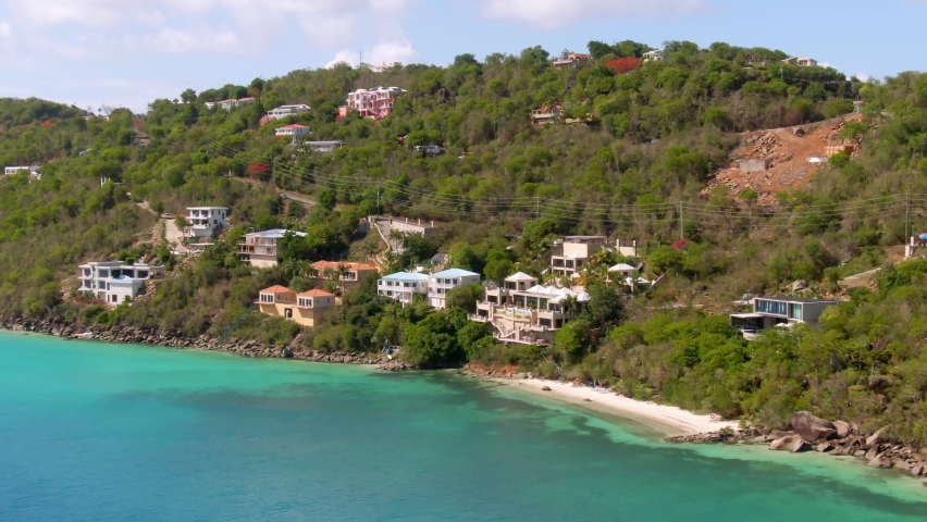 Aerial dolly showing beautiful waters and housing area in St Thomas UK Virgin Islands