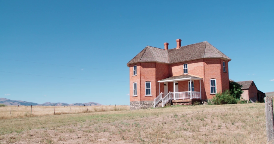 Wide shot of a historic home in Chesterfield Idaho on a warm sunny day.
