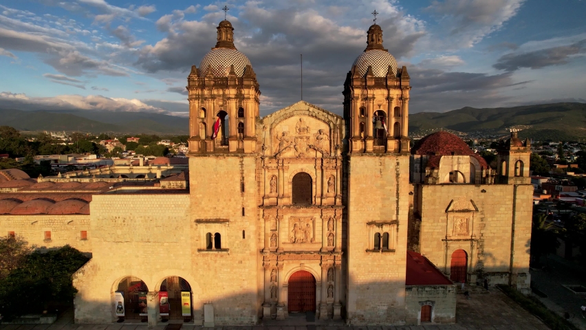 backwards drone shot of Santo Domingo temple in downtown Oaxaca city in Mexico Royalty-Free Stock Footage #1096146061