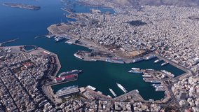 Aerial drone cinematic video of busy port of Piraeus, the largest in Greece and one of the largest passenger ports in Europe as seen from high altitude, Attica, Greece 
