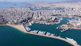 Aerial drone cinematic video of busy port of Piraeus, the largest in Greece and one of the largest passenger ports in Europe as seen from high altitude, Attica, Greece 
