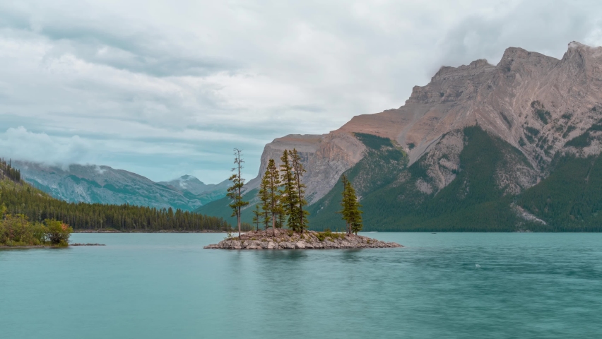 4K time-lapse UHD video of Small island with trees on  Minnewanka lake,a Glacial Lake and the 2nd longest lake in the mountain parks of the Canadian Rockies in Banff Alberta Canada