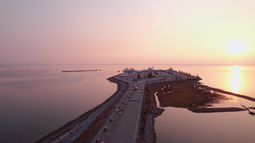 Ferry terminal with cars unloading, BC Ferries, Tsawassen, aerial footage, sunset. 