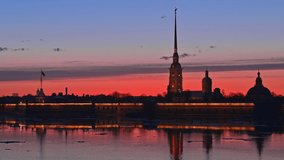 One of the most famous local Peter and Paul fortress in colorful sunset, view with reflection in river in Saint-Petersburg, Russia. Spring, ice floats