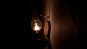 An old kerosene lamp hanging on the wall