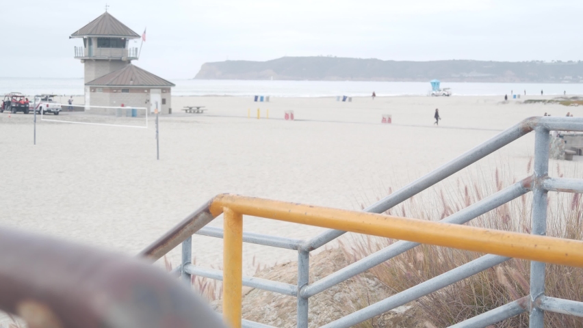 Lifeguard stand or life guard tower hut, surfing safety on California beach, USA. Rescue station, coast lifesavers wachtower or house, Coronado ocean beach, San Diego. Beach access stairs or steps.