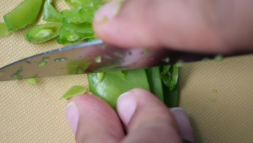 women cutting Holland beans on the cutting board