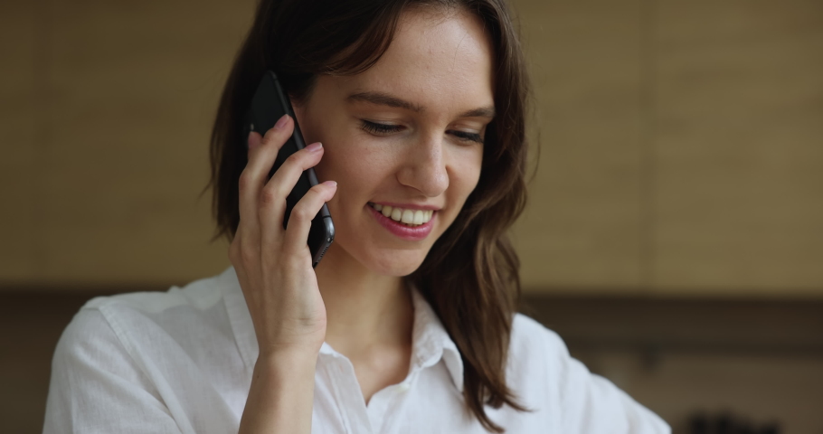 Close up happy young woman standing indoor talks on smartphone. Attractive businesslady makes business call, having pleasant conversation use cellphone. Modern technology, remote communication concept Royalty-Free Stock Footage #1096164963