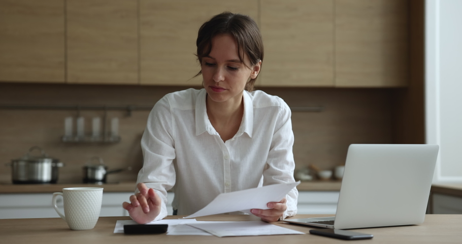 Young 30s woman annoyed with debt or mistake in report feels irritated doing accounting job at home, calculates expenses having finances problem, lack of money, financial concerns, bankruptcy concept Royalty-Free Stock Footage #1096165171