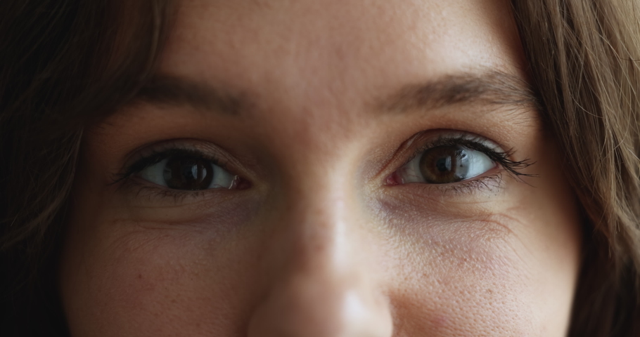 Female brown eyes staring at camera, close up cropped upper part of face. Smiling woman look at cam advertise lenses for comfort life, eyecare, eyesight check up in clinic, vision correction concept Royalty-Free Stock Footage #1096165221