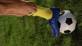 Close up of Football Player Putting On Sock. Soccer Player Adjusts Equipment Before Walkout to Pitch Before Match, Slow motion. Soccer World Cup. Vertical Video