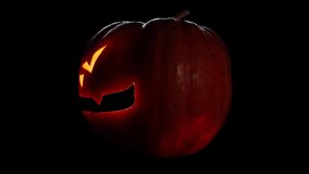 Scary pumpkin head with candles inside. Rotation on a black background. Close-up. Halloween holiday concept - Powered by Shutterstock - Get 15% off with code: PIKWIZARD15