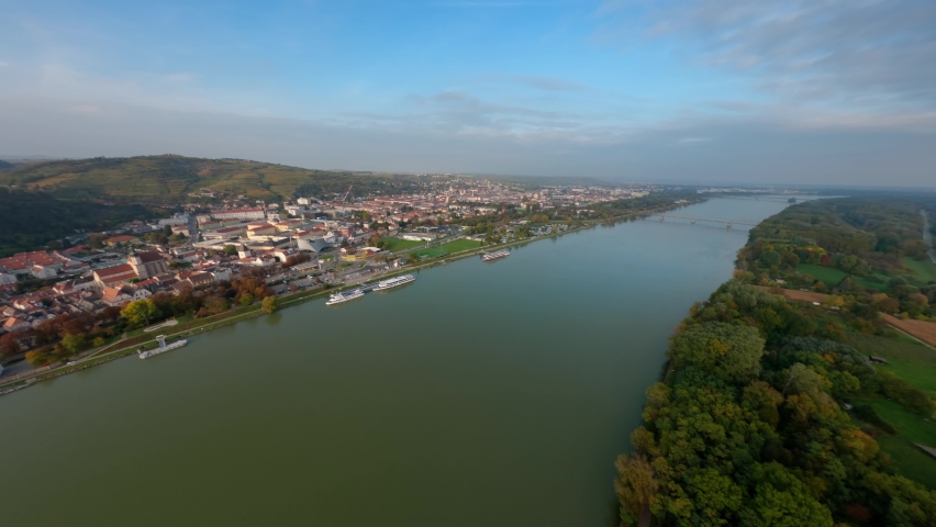 Slow rotating aerial shot of the cities Stein and Krems an der Donau with their beautiful surrounding hills and nature.