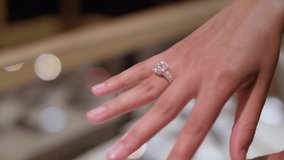 Bride is trying beautiful diamond before wedding ring in the jewelry store - Powered by Shutterstock - Get 15% off with code: PIKWIZARD15