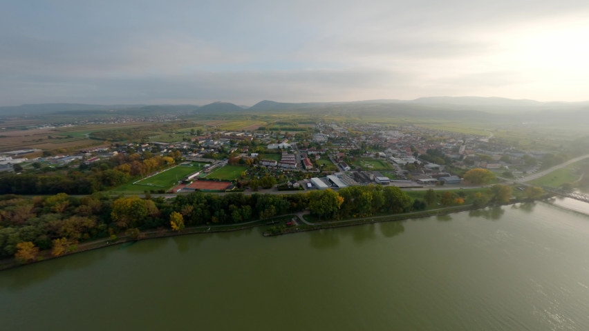 Slow rotating aerial shot of Mautern an der Donau with beautiful surrounding hills and nature.