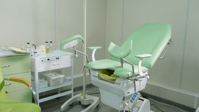 Gynecological chair in medical office moving up. consulting gynecologist in hospital. Gynecological female health. Gynecology concept. Gynecological Examination Chair In Cabinet Interior. 4 k video