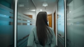 Back view employee walking on meeting through office corridor. Closeup professional woman thinking about project in business center hallway. Serious manager going on dinner in open space alone  - Powered by Shutterstock - Get 15% off with code: PIKWIZARD15