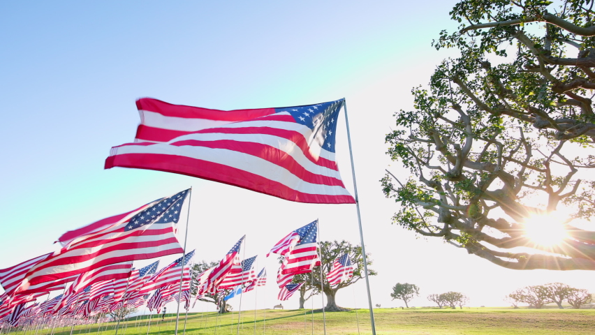 Iconic Waves of Flags on annual ceremony at Pepperdine University, CA, USA. Shot of honoring the lives lost in the terror attacks on September 09,11, 2001. Sun Flare. High quality 4k footage Royalty-Free Stock Footage #1096194007