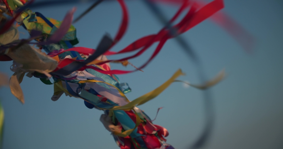 Buddhist colored ribbons jalama 
develop and sway in the wind in ultra slow motion 4k close-up shot from Baikal lake.