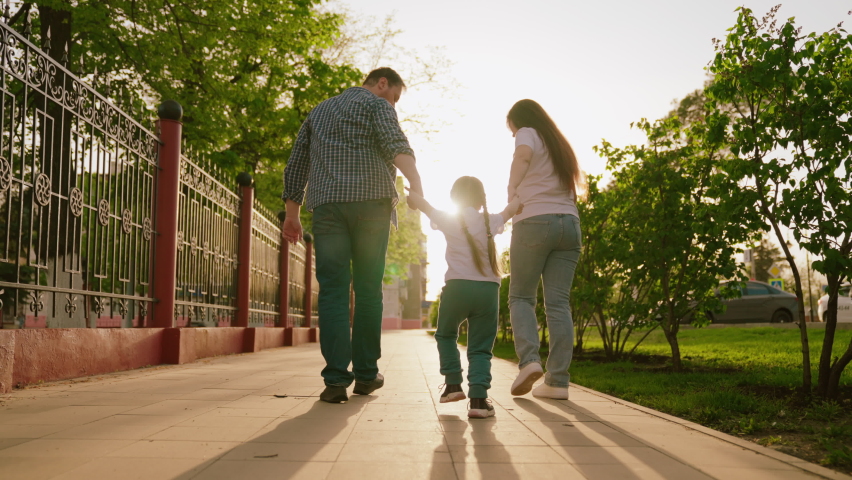 happy family. mother father child run through park sunset. mom dad kid fun running sun. view from back. happy family park. chidhood dream. family walk with kid around city playing. run teamwork Royalty-Free Stock Footage #1096203999