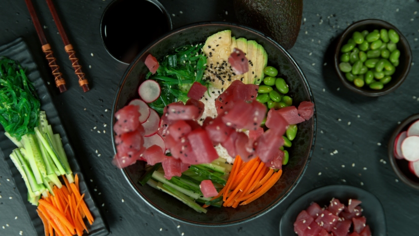 Super Slow Motion Shot of Fresh Tuna Cuts Falling into Poke Bowl at 1000fps. Royalty-Free Stock Footage #1096204713