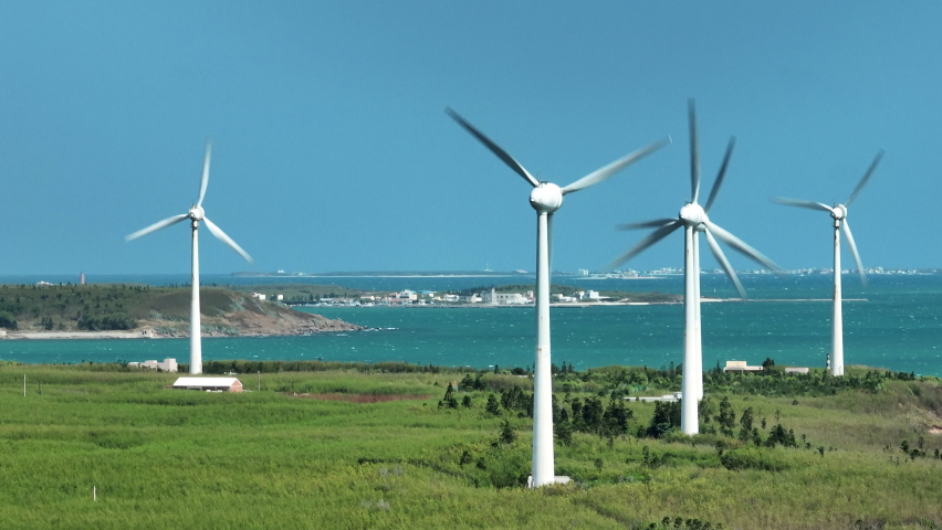 Aerial view of giant wind turbines standing in the green field by the beach in a seaside park , Penghu County, Taiwan. Royalty-Free Stock Footage #1096207857